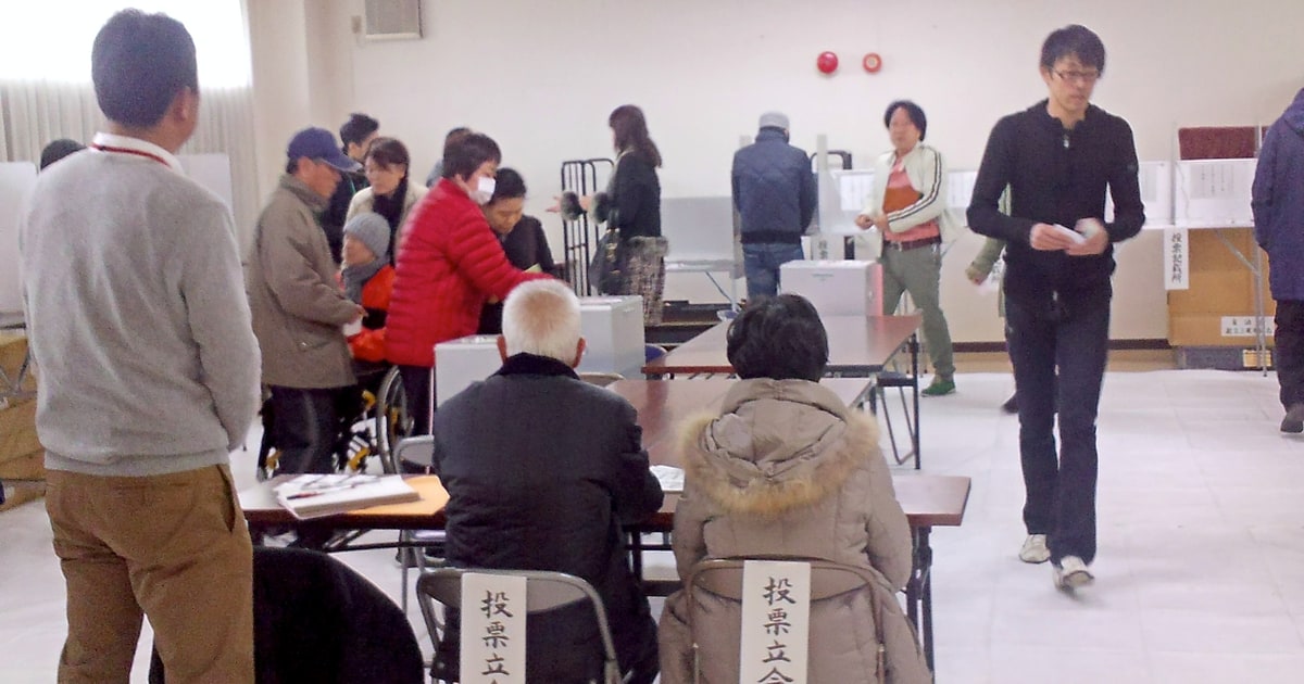Voters and election staff at a polling station in Higashi-Osaka during Japan’s 2014 general election.