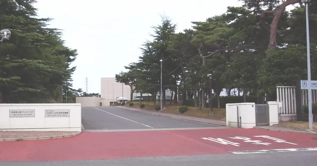 Entrance gate of the Japan Atomic Energy Agency site in Tokai-mura, Ibaraki, with the agency’s name plate on the gate wall.