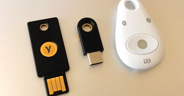 Two Yubico USB security keys and a Feitian security token used for hardware-based authentication.